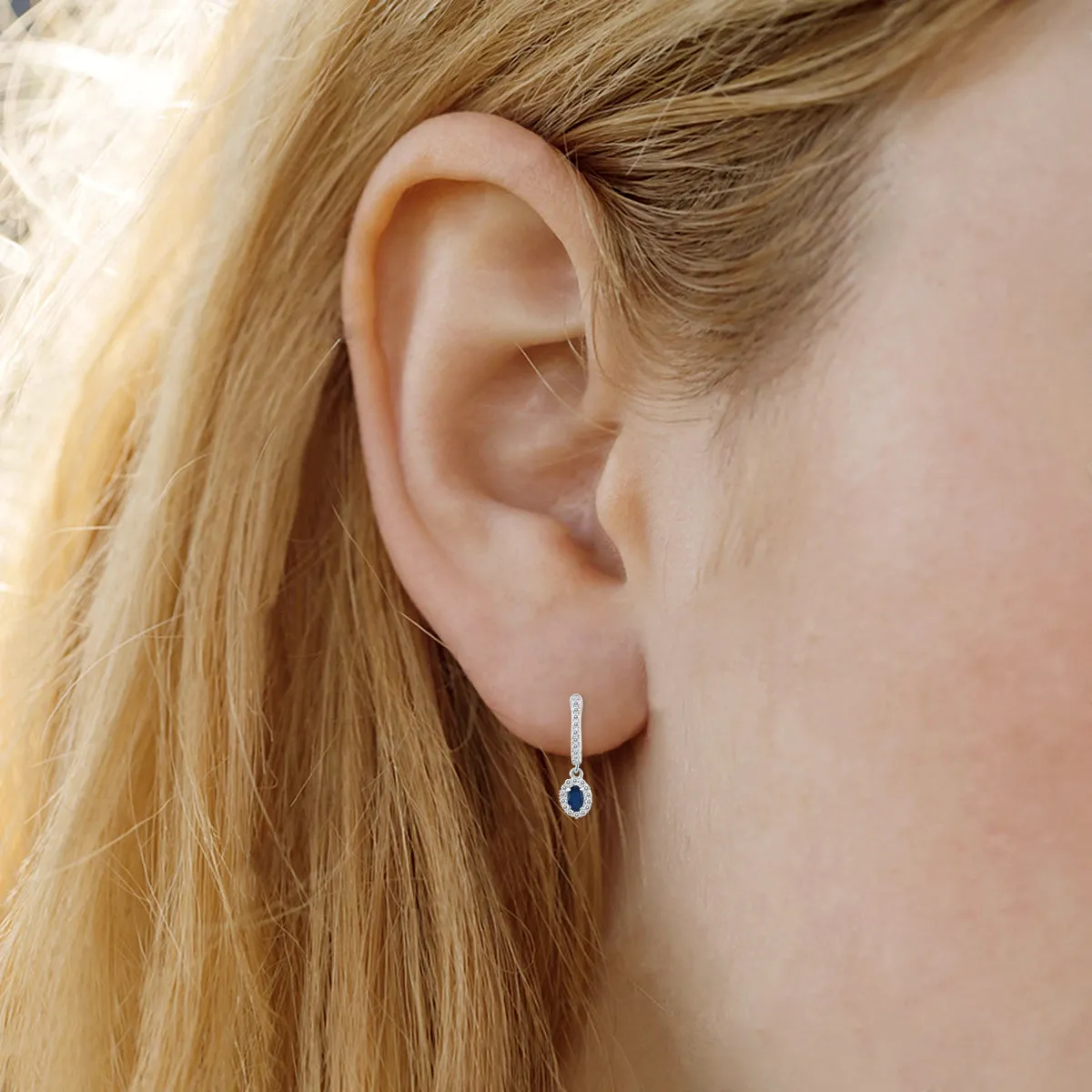 1/2 Carat Oval Sapphire And Diamond Halo Dangle Earrings In 10K White Gold